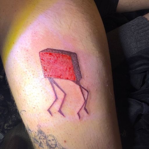 Тату на ноге: красный куб на тонких ножках